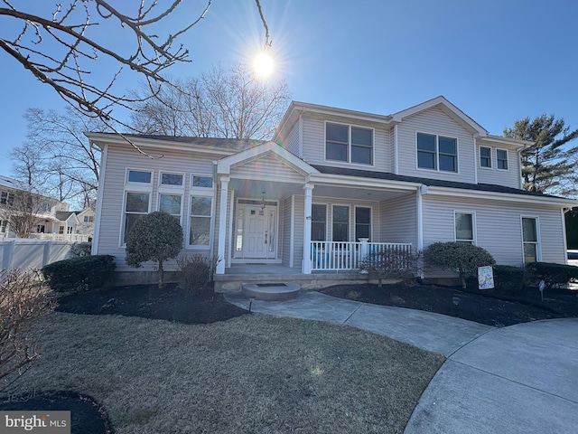 view of front of home with covered porch and fence