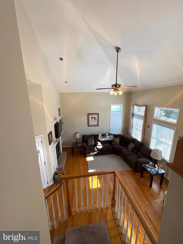 unfurnished living room with lofted ceiling, ceiling fan, and wood finished floors