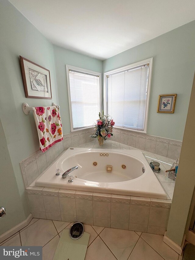 full bath featuring a tub with jets and tile patterned floors