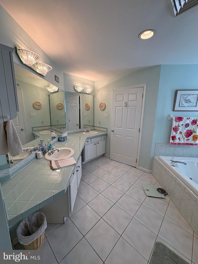 bathroom featuring a sink, double vanity, tile patterned flooring, and a garden tub