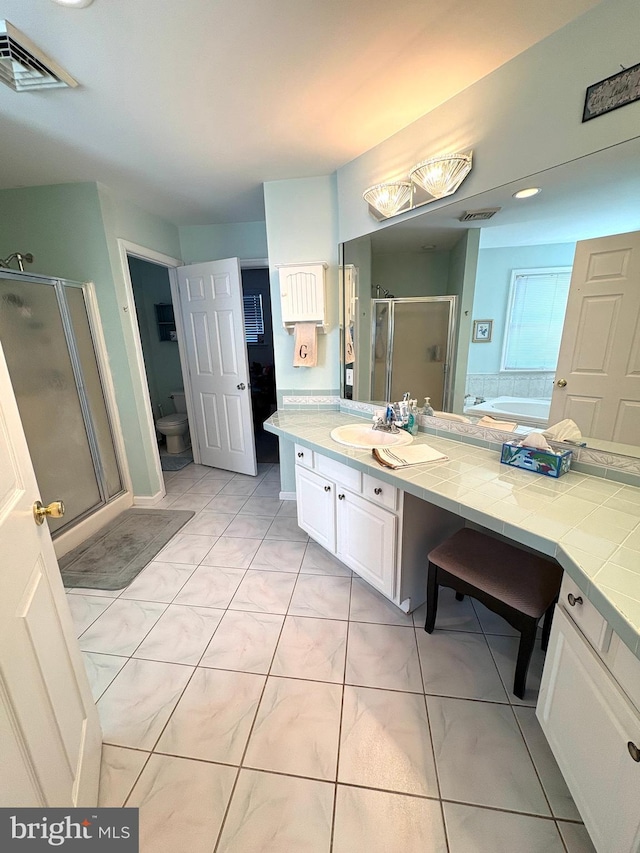 bathroom with a bath, toilet, a stall shower, and visible vents