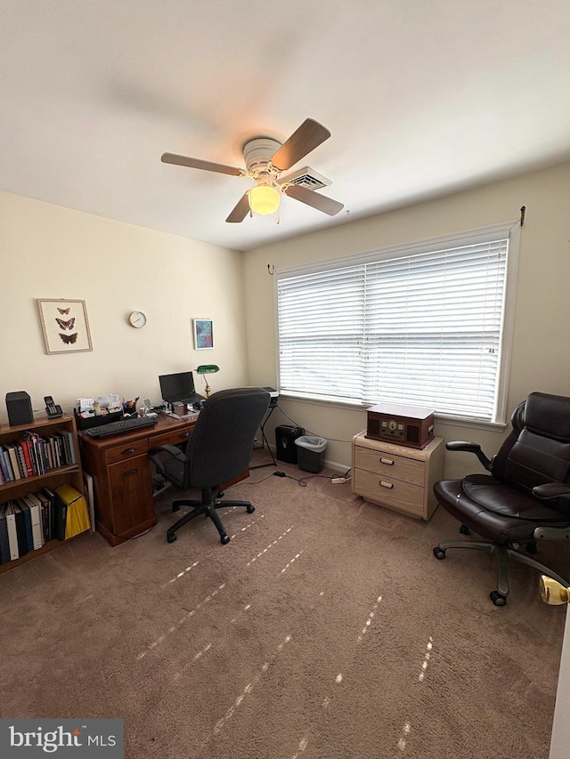 carpeted home office with a ceiling fan