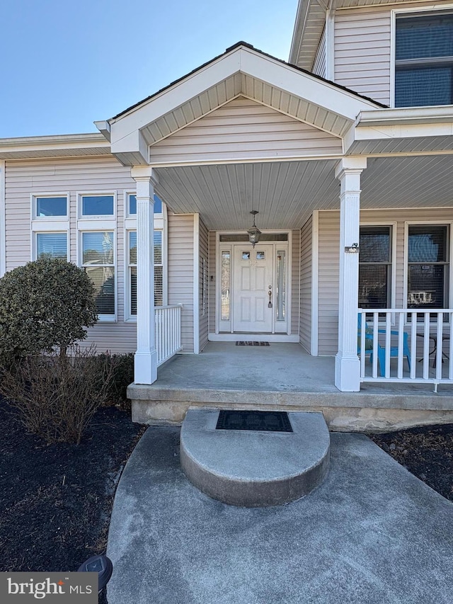 view of exterior entry featuring a porch