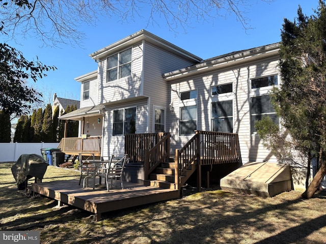 back of house featuring a wooden deck and fence