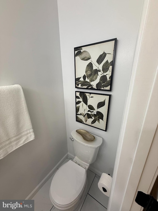 bathroom with toilet and baseboards