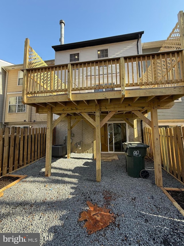 rear view of house featuring central AC unit, fence, a patio, and a wooden deck