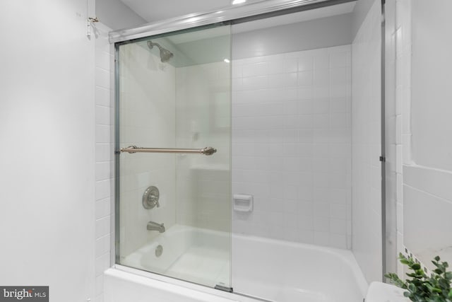 full bathroom with bath / shower combo with glass door