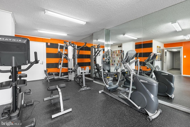 exercise room featuring a textured ceiling