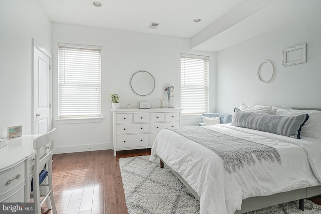 bedroom with recessed lighting, visible vents, baseboards, and wood finished floors