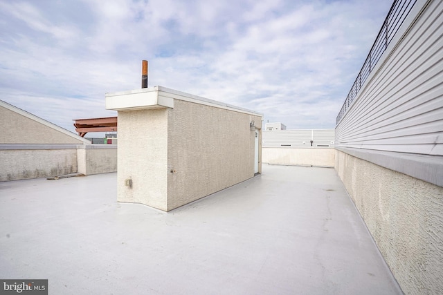 view of home's exterior with stucco siding and a patio