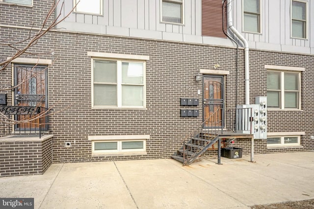 exterior space with brick siding and board and batten siding