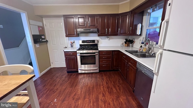 kitchen featuring under cabinet range hood, appliances with stainless steel finishes, light countertops, and a sink