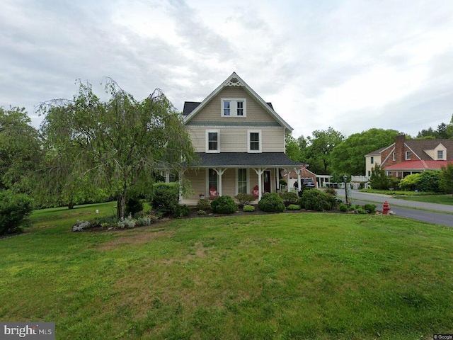 victorian home featuring a porch and a front yard