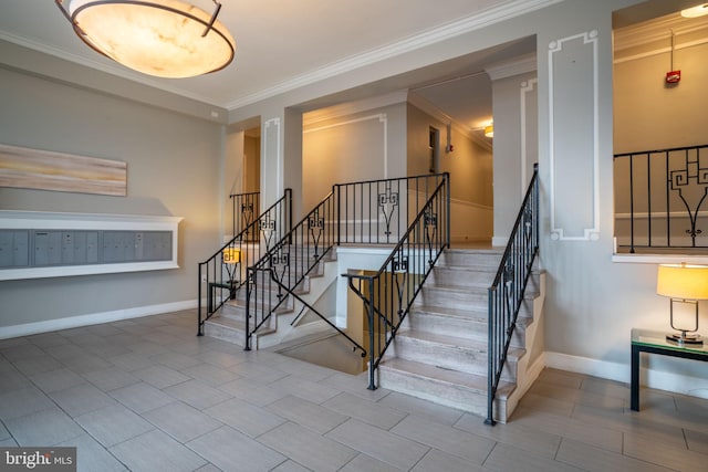 stairs with mail area, baseboards, and ornamental molding