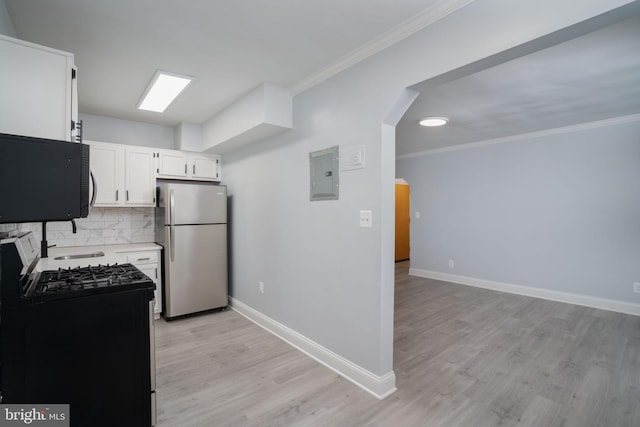 kitchen featuring electric panel, arched walkways, ornamental molding, black appliances, and white cabinetry