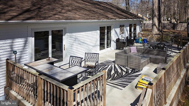 deck featuring an outdoor living space and outdoor dining area