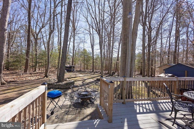 wooden deck with an outdoor fire pit