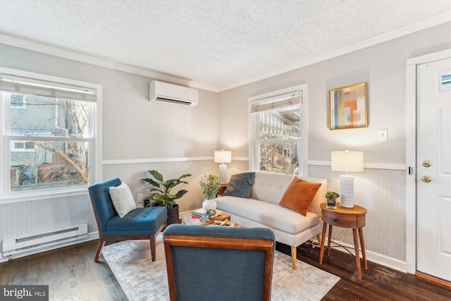 sitting room with a textured ceiling, a baseboard heating unit, an AC wall unit, wainscoting, and hardwood / wood-style floors