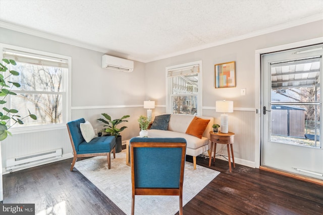 sitting room with a textured ceiling, baseboard heating, wood-type flooring, and a wall mounted AC