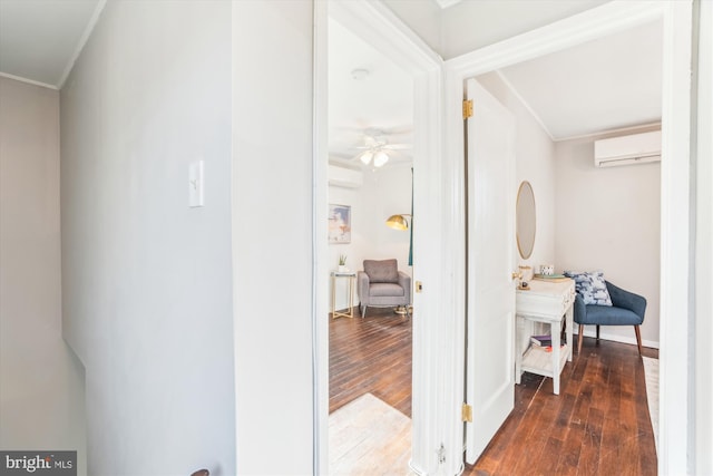 corridor with baseboards, crown molding, hardwood / wood-style floors, and a wall mounted AC