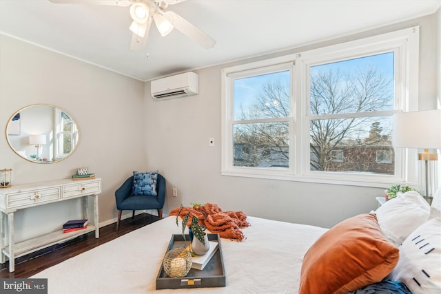 bedroom with a wall unit AC, wood finished floors, a ceiling fan, and baseboards