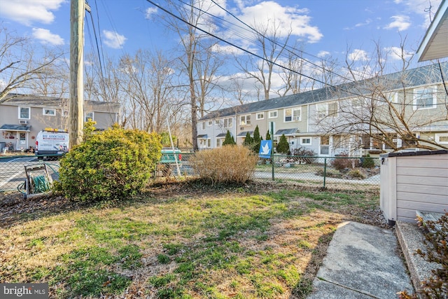 view of yard with a residential view and fence