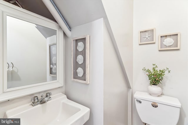 half bath featuring a sink and toilet