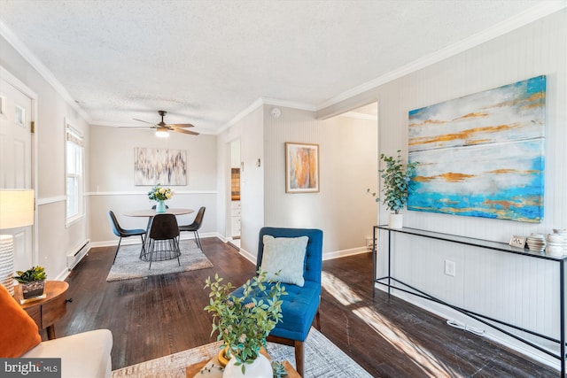 dining space featuring a baseboard heating unit, crown molding, a textured ceiling, and wood finished floors