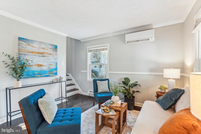 living area with crown molding, baseboard heating, a wall mounted AC, a textured ceiling, and wood finished floors