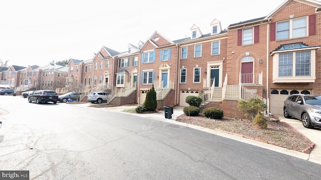 view of front facade with a residential view and brick siding