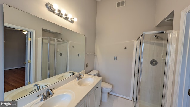 bathroom featuring a stall shower, visible vents, and a sink