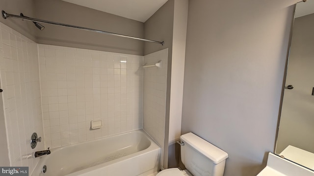 bathroom with toilet and  shower combination