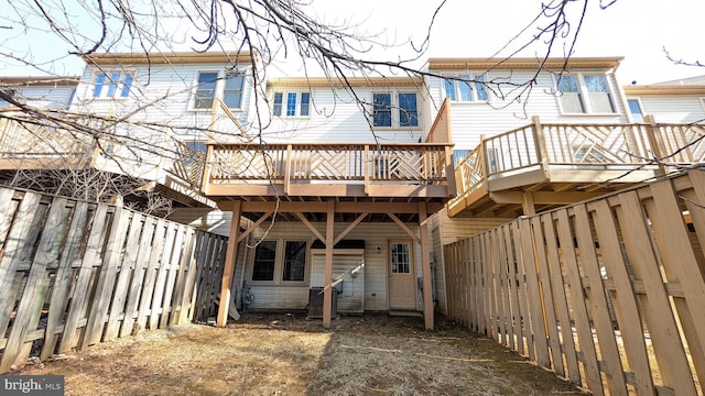 back of property featuring a wooden deck and a fenced backyard