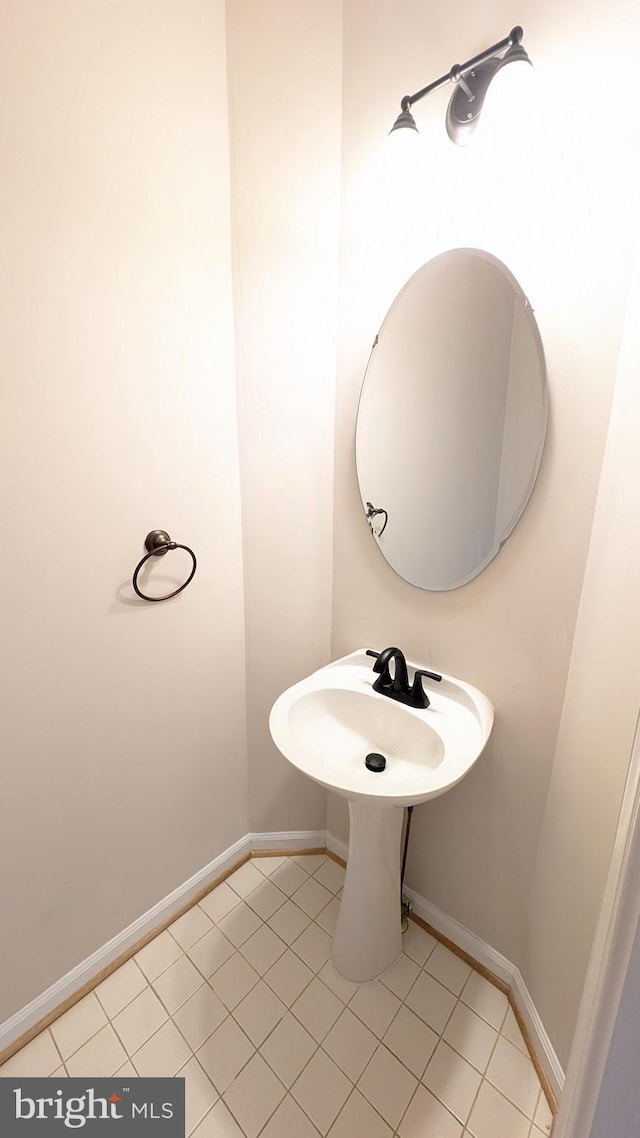 bathroom with tile patterned floors and baseboards