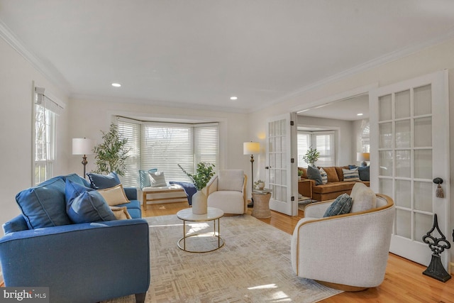 living area with recessed lighting, french doors, crown molding, and wood finished floors