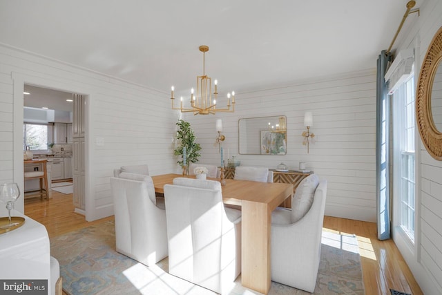 dining room with a chandelier and light wood finished floors