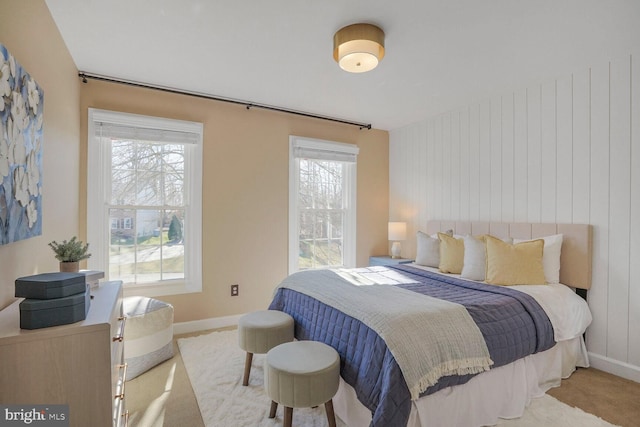 bedroom with carpet floors, multiple windows, and baseboards