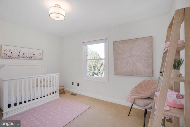 carpeted bedroom featuring a nursery area, visible vents, and baseboards