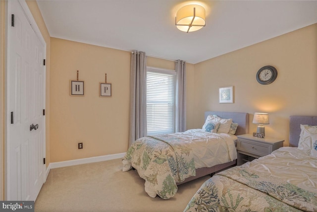 bedroom with carpet floors and baseboards