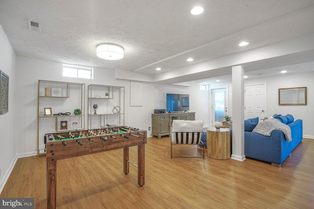 game room with recessed lighting, visible vents, a textured ceiling, and wood finished floors