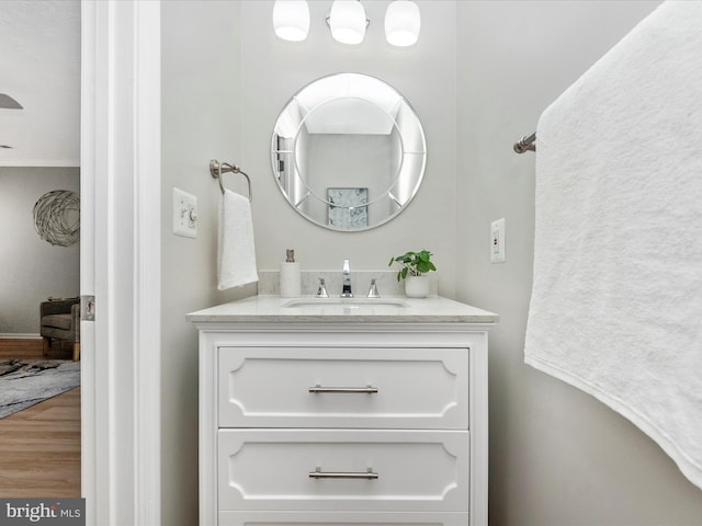 bathroom with wood finished floors and vanity