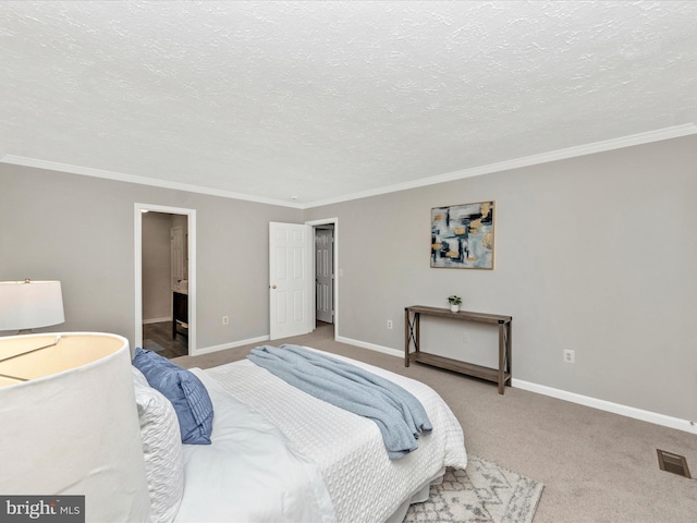 carpeted bedroom featuring baseboards, visible vents, a textured ceiling, and ornamental molding