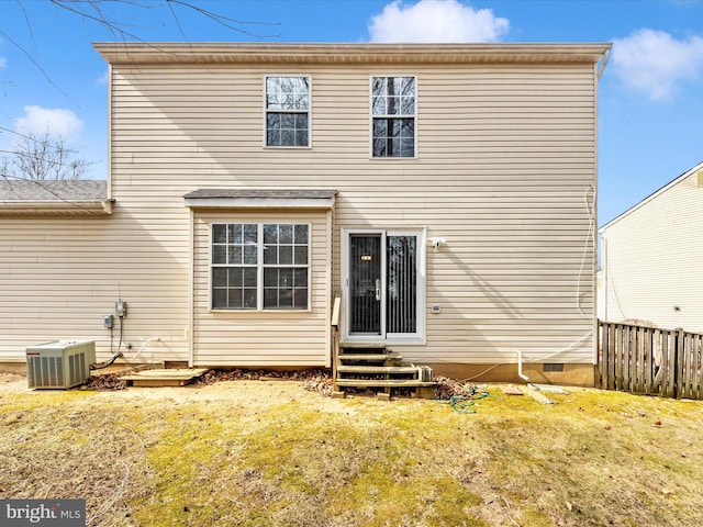 rear view of property with a yard, central air condition unit, entry steps, crawl space, and fence