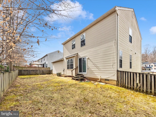 rear view of property with entry steps, a fenced backyard, a yard, and central AC unit