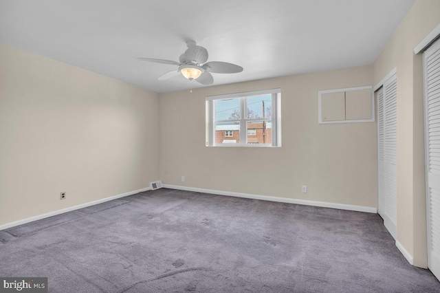 unfurnished bedroom with ceiling fan, visible vents, baseboards, and carpet flooring