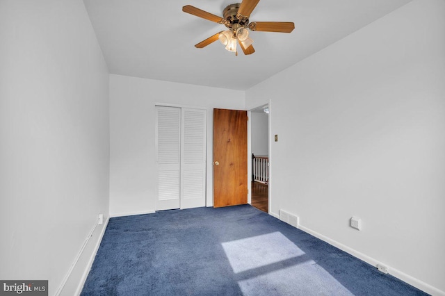 unfurnished bedroom featuring carpet, a closet, visible vents, and baseboards