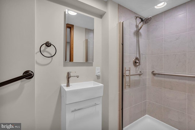 full bathroom featuring a stall shower and vanity