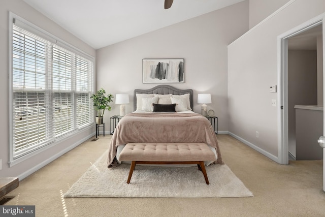 bedroom with lofted ceiling, a ceiling fan, baseboards, and light carpet