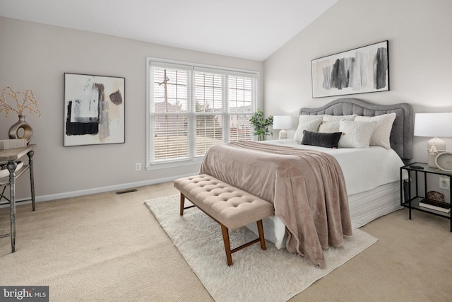 bedroom featuring light carpet, visible vents, baseboards, and lofted ceiling