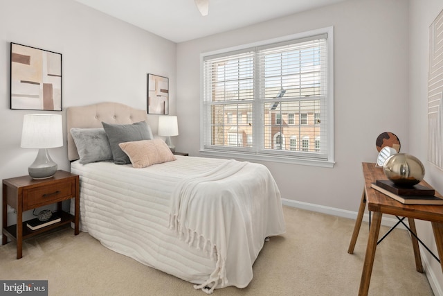 bedroom with light carpet and baseboards